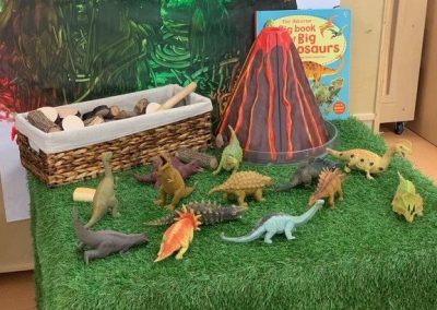 An image of a play area with dinosaurs prop in a small childcare centres near me.