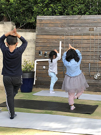 An image of children doing yoga in one of the best daycare centres near me.