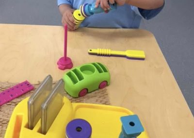 An image of a kid playing with toys in the kids early learning centre.