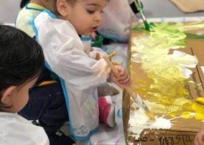 An image of kids painting in the early learning centre.